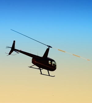 helicopter flying against the evening sky