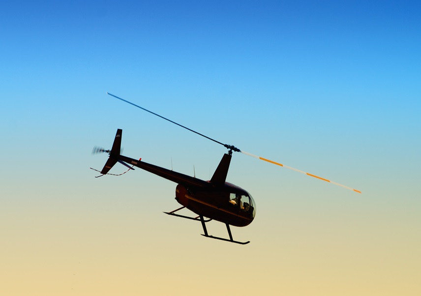 helicopter flying against the evening sky
