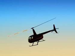 helicopter flying against the evening sky